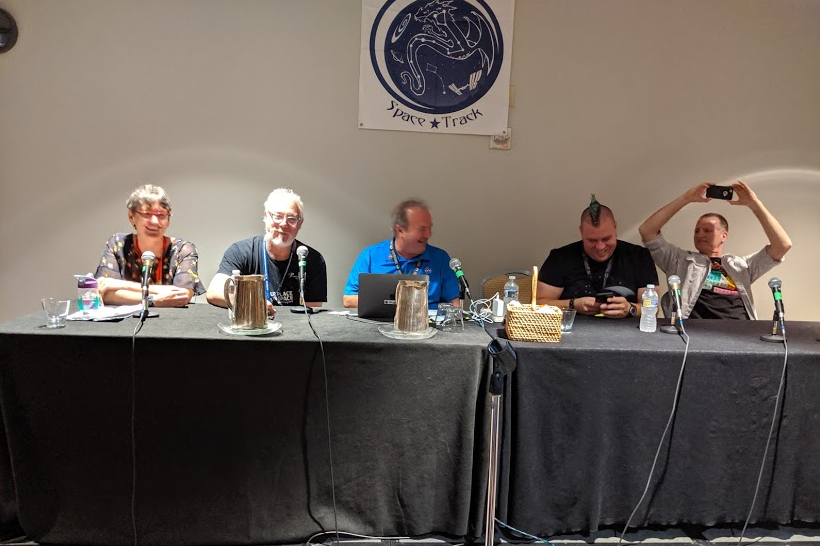 Reveals team members at a DragonCon panel